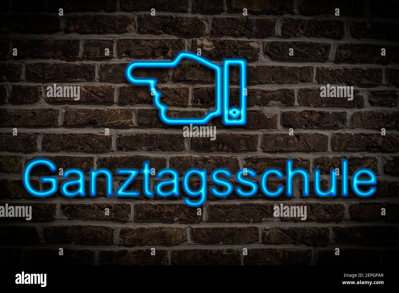 Detail photo of a a neon sign on a wall with the inscription Ganztagsschule (full-time school) Stock Photo
