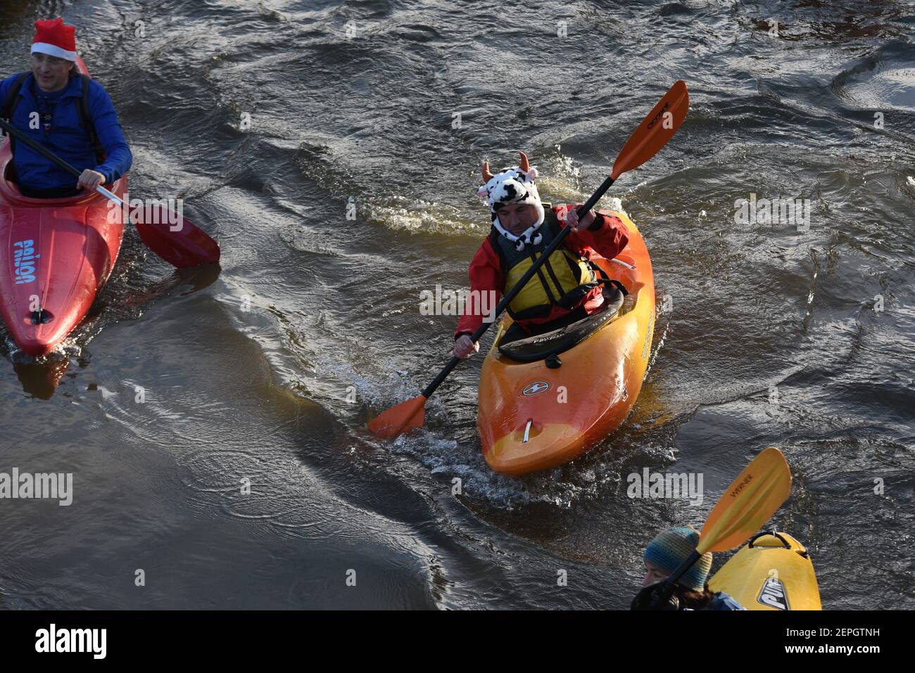 A reveller paddles her canoe during the event. Villagers of Soria made
