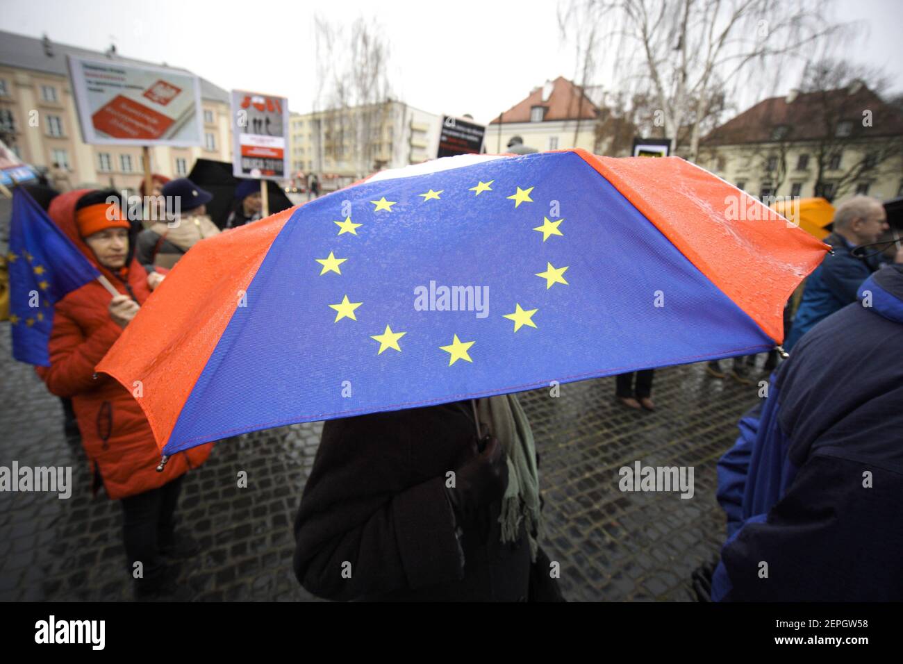 A woman holds an umbrella with an EU flag depicted on it during a  demonstration in Warsaw, Poland on December 23, 21019 against the sudden  suspension of Pawel Juszczyszyn. Juszczyszyn is a