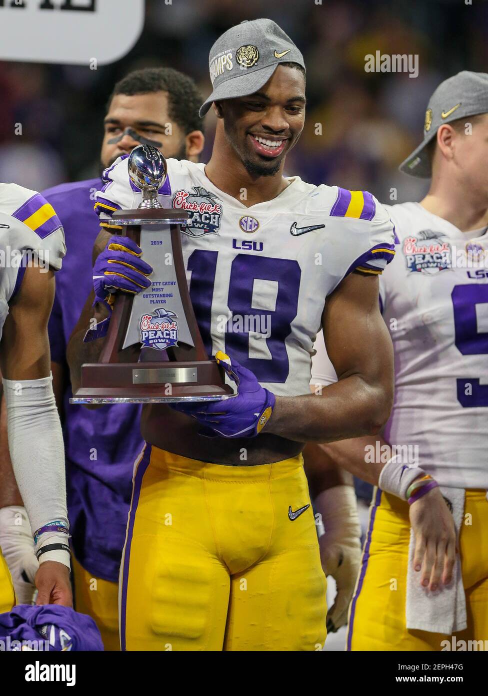 December 28, 2019: K'Lavon Chaisson (18), LSU's Defensive MVP, poses with the trophy after the Chick-Fil-A Peach Bowl Playoff Semifinal game between the Oklahoma Sooners and the LSU Tigers at the Mercedes Benz Stadium in Atlanta, GA. LSU defeated Oklahoma 63-28. Jonathan Mailhes/(Photo by Jonathan Mailhes/CSM/Sipa USA) Stock Photo