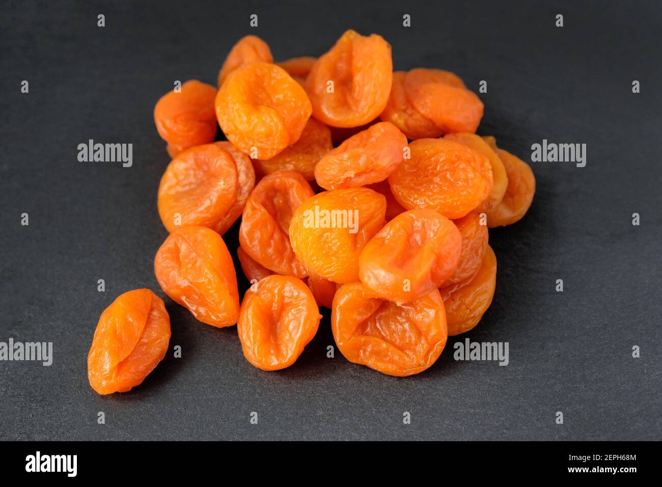 Large dried apricots on a black background. Dried apricot fruits