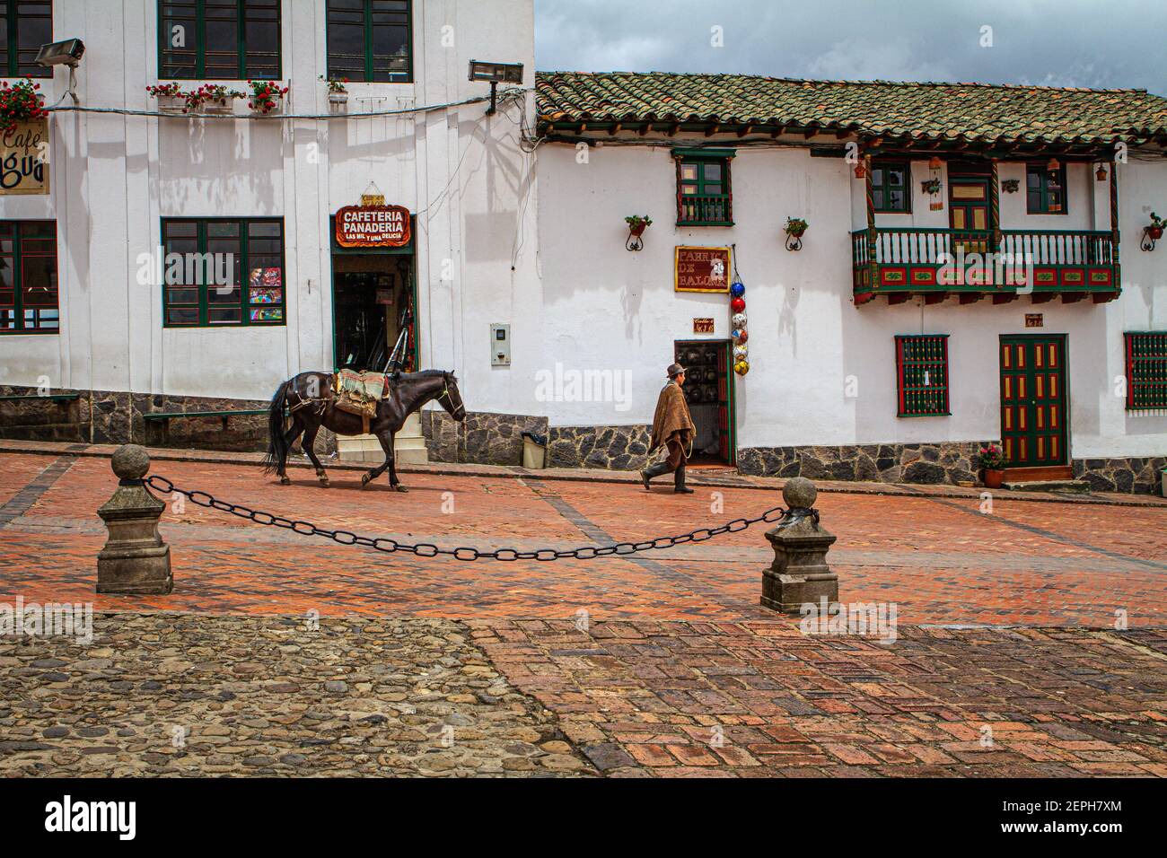 horse, with Colombian farmer traditional poncho, ruana, hat.500 year old town.Colonial, Plaza de Bolívar, Tunja, Boyaca, Colombia Andes, South America Stock Photo