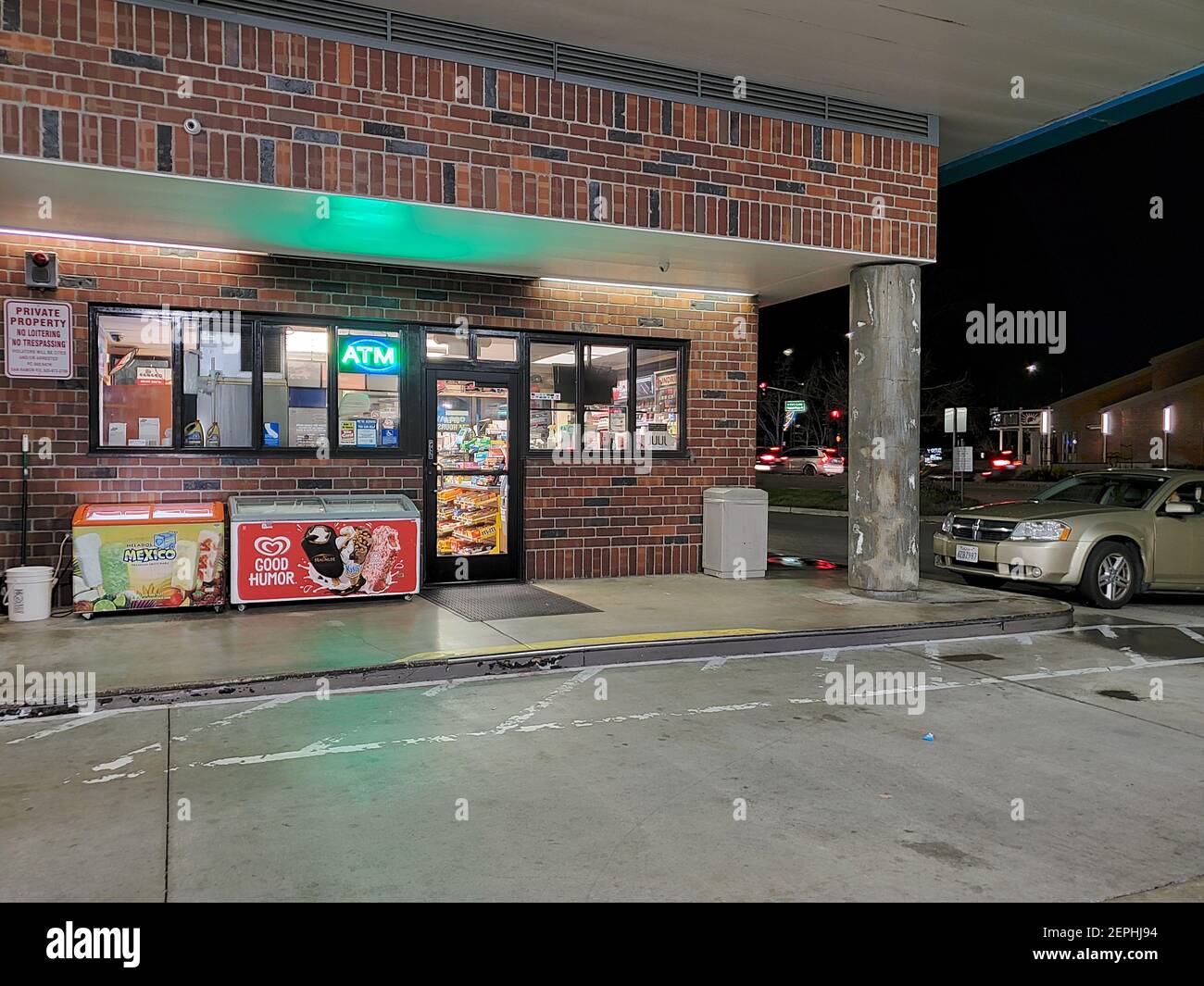 Night view of gas station convenience store with brightly lit windows