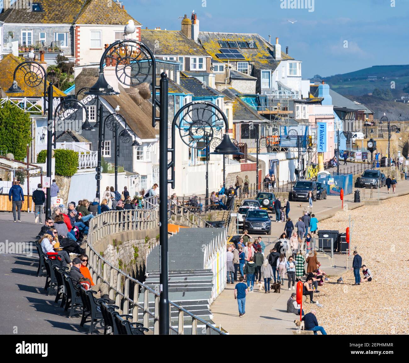 Lyme Regis, Dorset, UK. 27th Feb, 2021. UK Weather: Plenty of people were out and about enjoying unseasonably warm and sunny weather at the seaside resort of Lyme Regis this afternoon. Credit: Celia McMahon/Alamy Live News Stock Photo