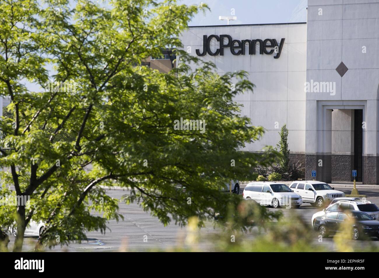 A logo sign outside of a JC Penney retail store location in Provo, Utah