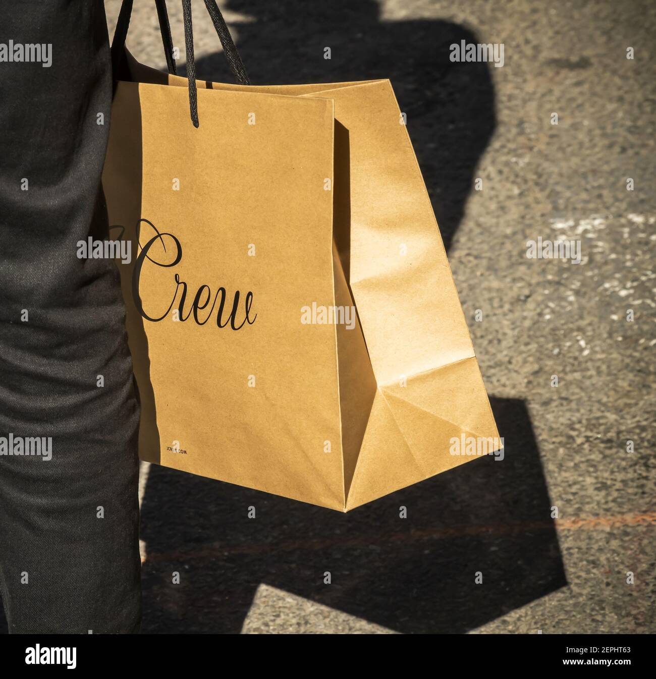 A shopper with his J.Crew shopping bag in Soho in New York on