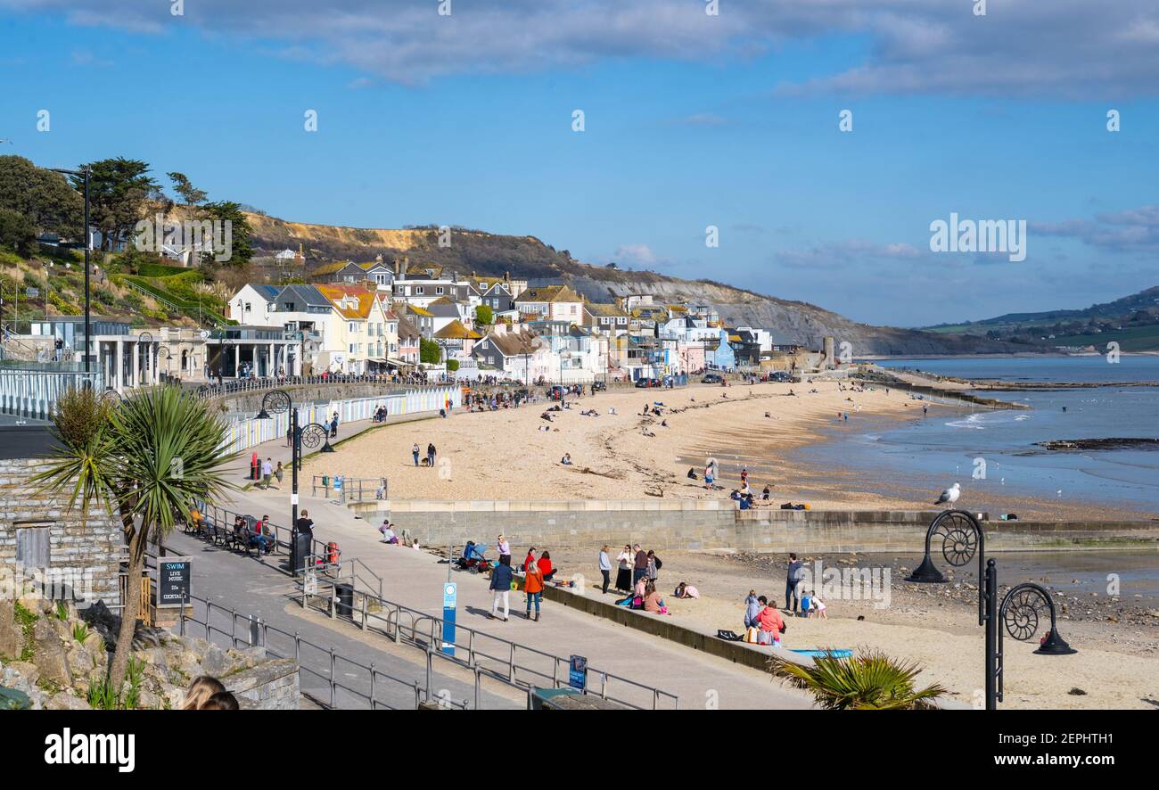 Lyme Regis, Dorset, UK. 27th Feb, 2021. UK Weather: Plenty of people were out and about enjoying unsesasonably warm and sunny weather at the seaside resort of Lyme Regis this afternoon. Credit: Celia McMahon/Alamy Live News Stock Photo
