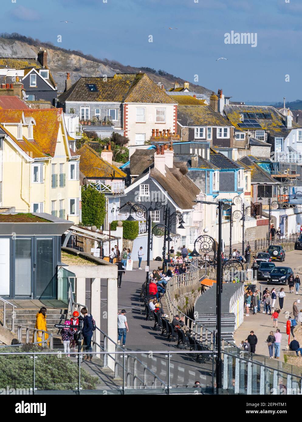 Lyme Regis, Dorset, UK. 27th Feb, 2021. UK Weather: Plenty of people were out and about enjoying unsesasonably warm and sunny weather at the seaside resort of Lyme Regis this afternoon. Credit: Celia McMahon/Alamy Live News Stock Photo