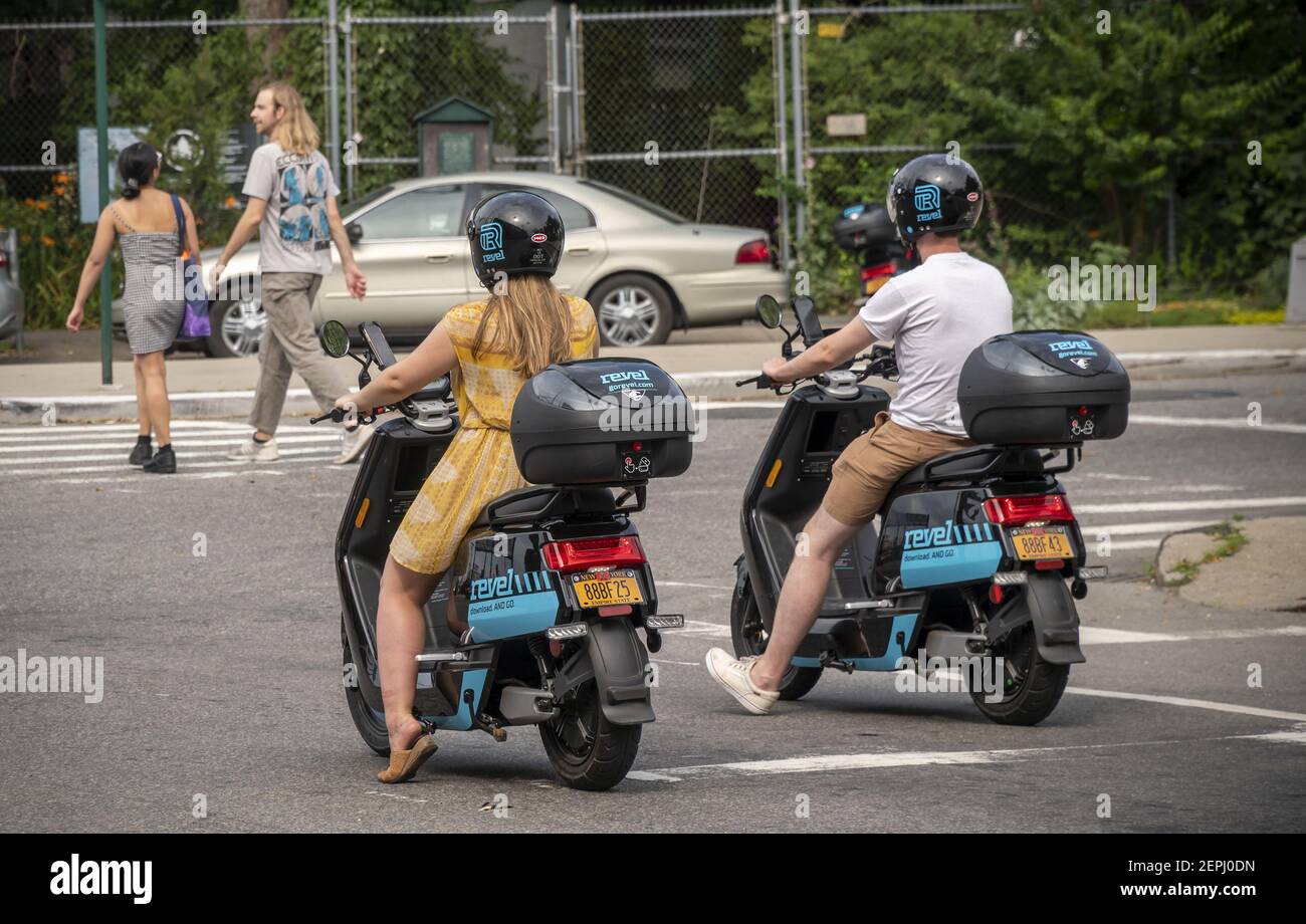 Riders travel on an electric moped from the moped sharing company Revel