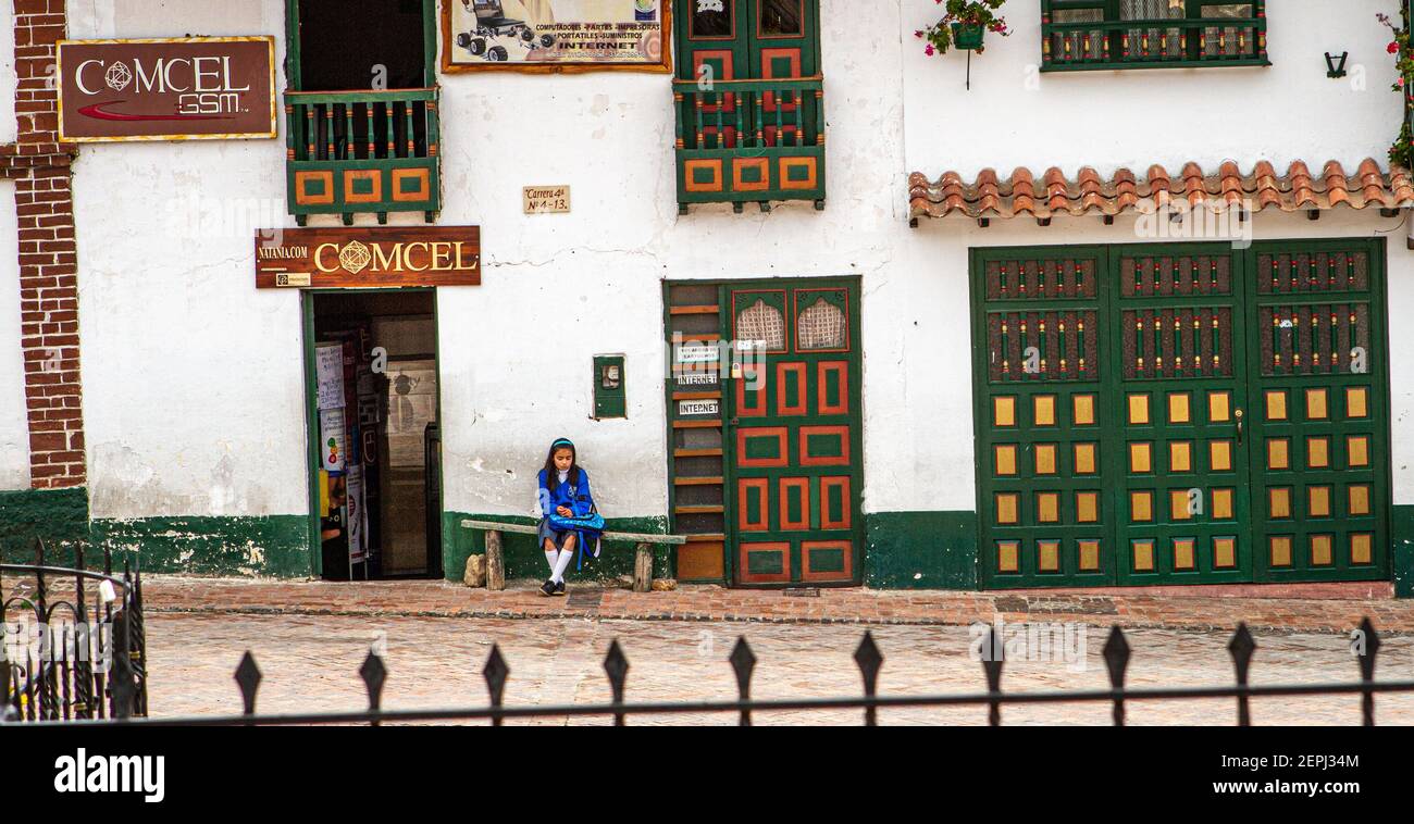 500 year town.school girl sitting.internet cafe,old green and gold building.Plaza de Bolívar,Tunja, Boyaca,Colombia, Colombian andes, South America Stock Photo