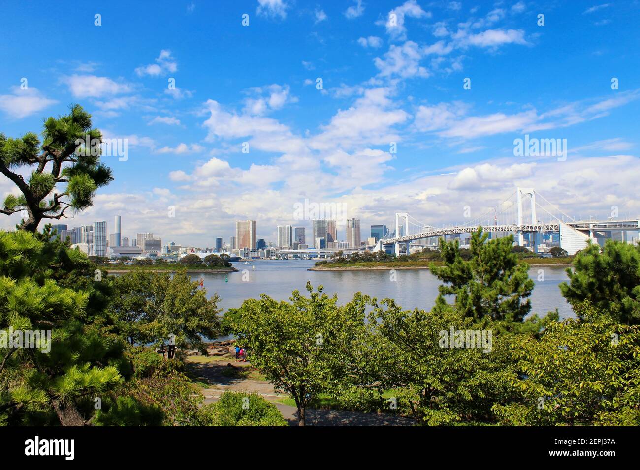 Panoramic view of Odaiba with Rainbow Bridge. Odaiba is a man-made island in Tokyo Bay and a popular entertainment and shopping district. Stock Photo
