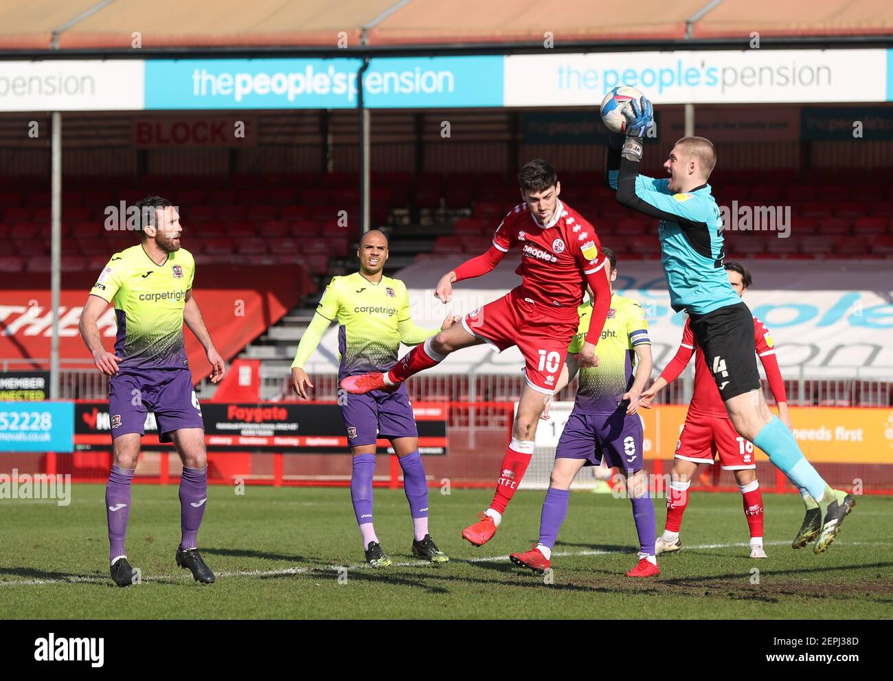 Crawley, UK. 27th Feb, 2021. Exeter's Jokull Andresson takes the ball off Crawley Town's Ashley Nadesan head during EFL Sky Bet League Two match between Crawley Town and Exeter City at the Peoples Pension Stadium in Crawley. Credit: James Boardman/Alamy Live News Stock Photo