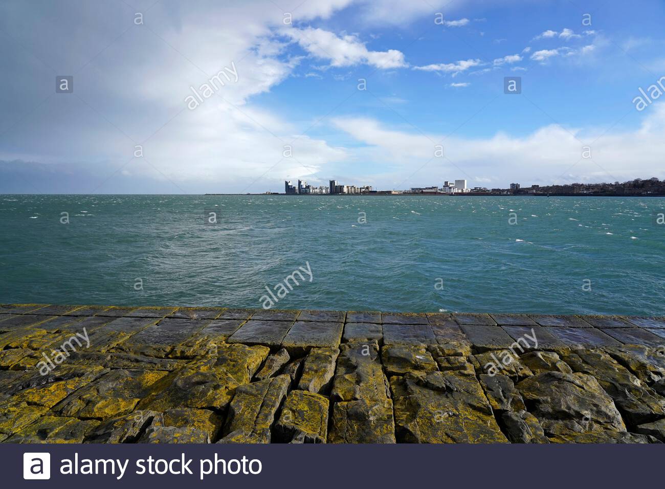 View over the Forth estuary towards the modern development at Leith from the breakwater at Granton harbour, Edinburgh, Scotland Stock Photo