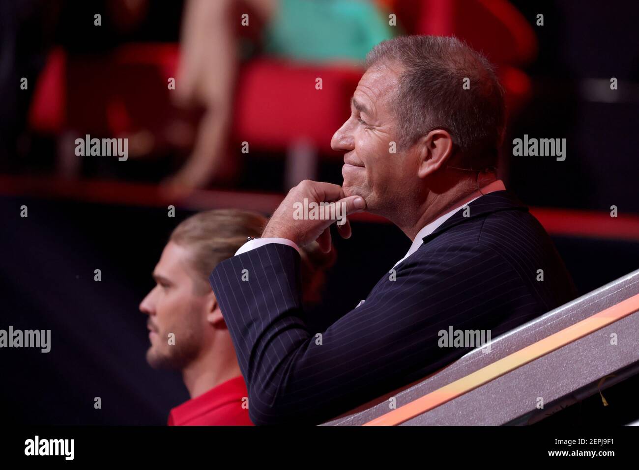 Cologne, Germany. 26th Feb, 2021. 'Let's Dance' - kick-off of the 14th season of the RTL dance show: sports presenter Kai Ebel (front) and soccer player Rurik Gislason sit in the audience area. In the first episode of 'Who dances with whom? Die große Kennenlernshow' reveals who will be dancing with which professional. Credit: Andreas Rentz/Getty-Pool/dpa/Alamy Live News Stock Photo