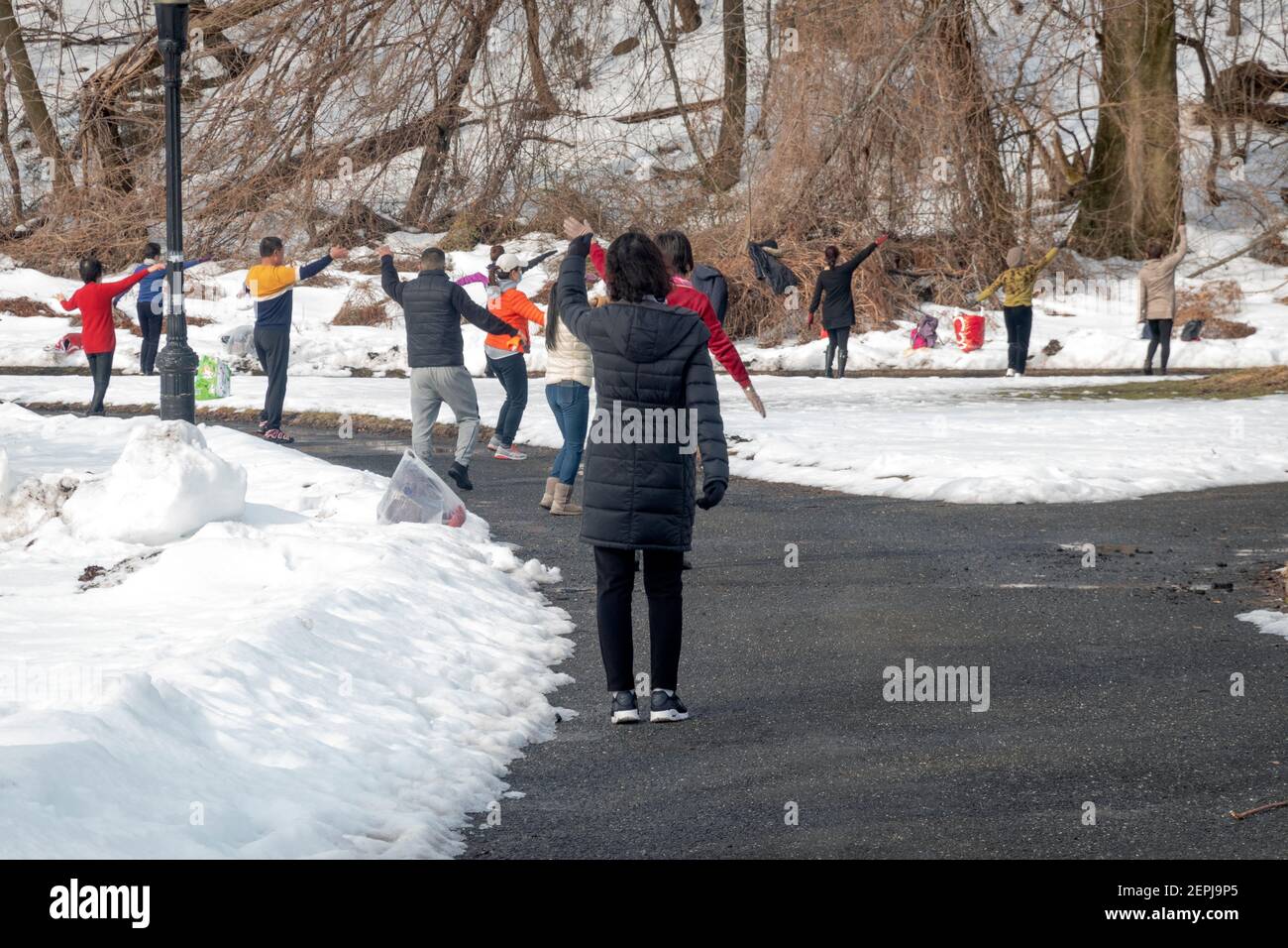 On a cold winter morning, Asian American women, primarily Chinese, attend a dance exercise class in a park in Flushing, Queens, New York City. Stock Photo