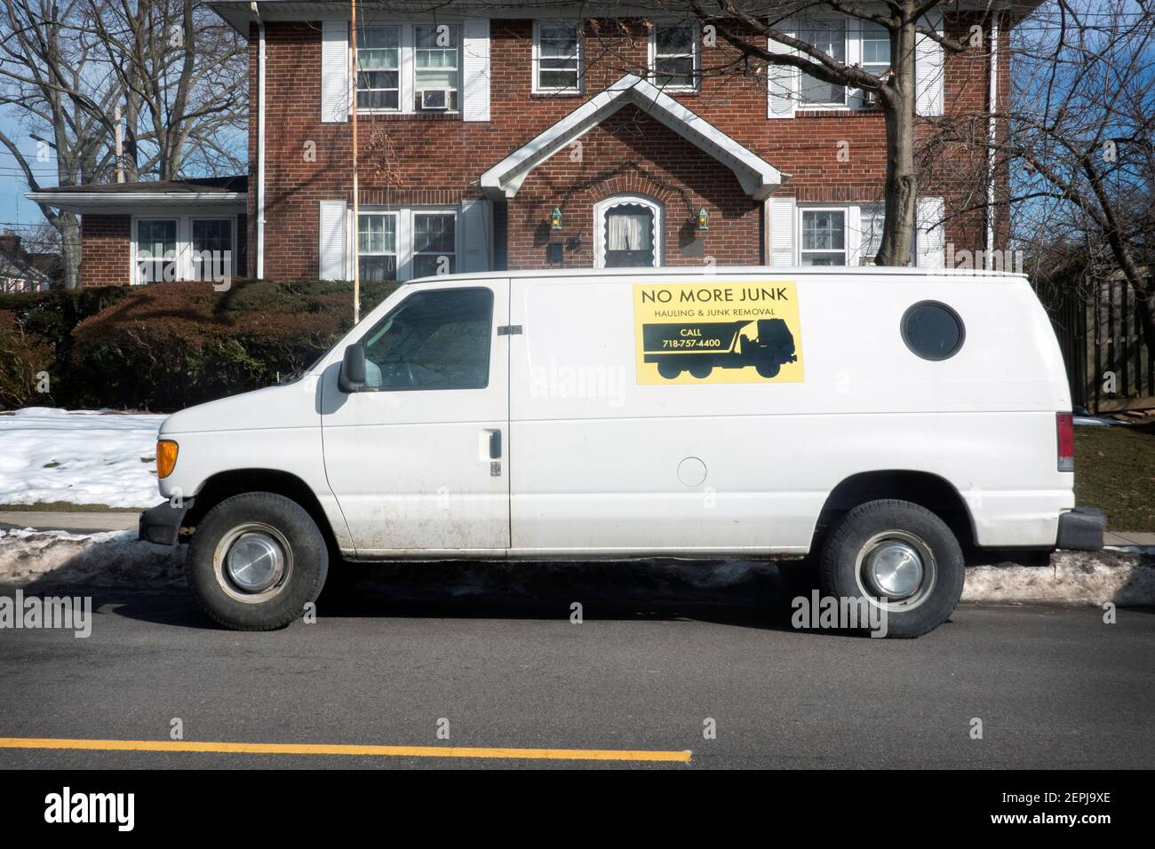 NO MORE JUNK. A parked truck van with a sign advertising for a hauling & junk removal service. In Queens, New York City. Stock Photo