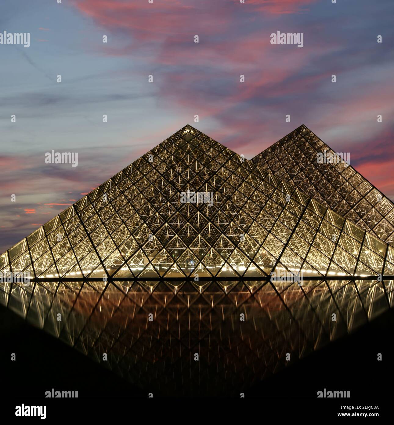 The Louvre Palace and the Pyramid, which was completed in 1989 (by night), France Stock Photo