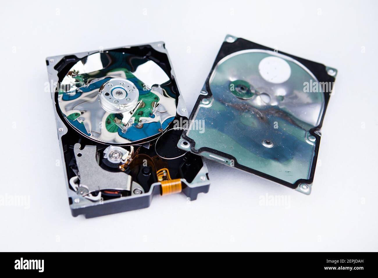 Crushed Hard Disk Drive on the White Table closeup Stock Photo