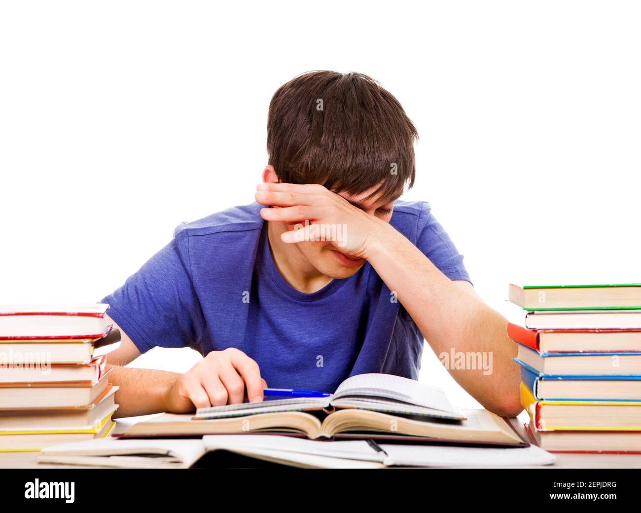 Tired Student Rub an Eyes on the School Desk Isolated on the White Background Stock Photo