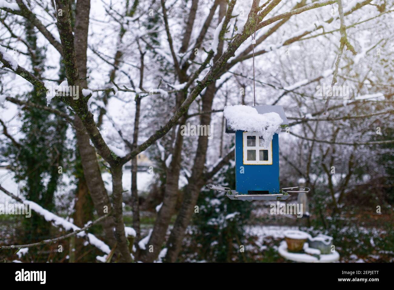 In The Garden In Winter Empty Bird Feeder Under The Snow Stock Photo