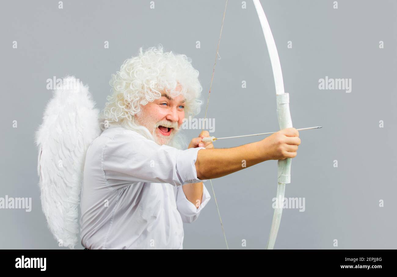 Valentines day. Smiling man in angel costume. Cupid with bow and arrows. God of love. Amour. Stock Photo