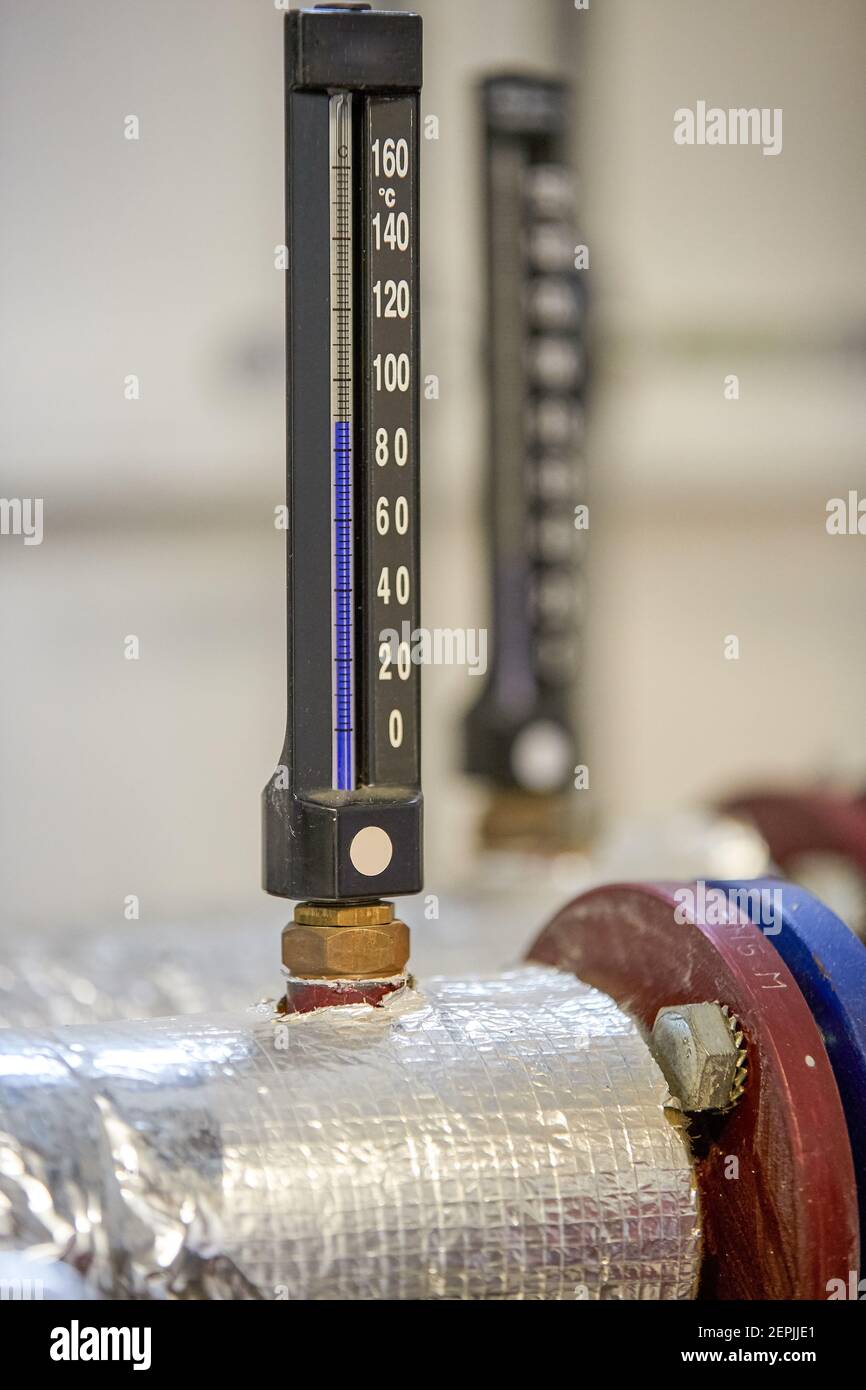 https://c8.alamy.com/comp/2EPJJE1/black-alcohol-thermometers-white-numbers-thermometers-and-pipes-of-heating-system-components-of-heating-technology-2EPJJE1.jpg