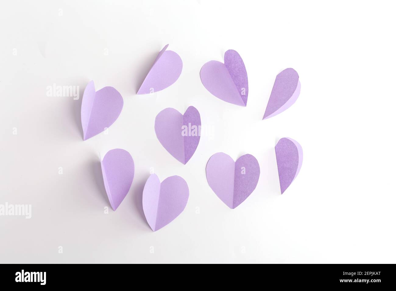 purple paper cut out heart for craft, step 2 of instruction, art project  paper flowers, DIY, spring holiday craft activity for kids Stock Photo -  Alamy
