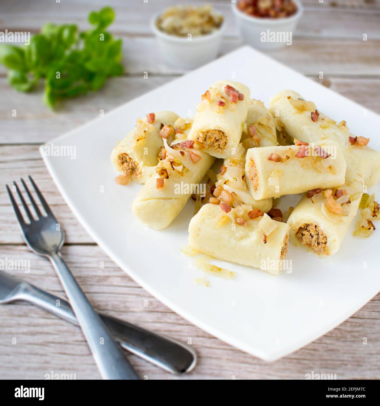 Potato dumplings with minced meat, cracklings, and onion. Stock Photo