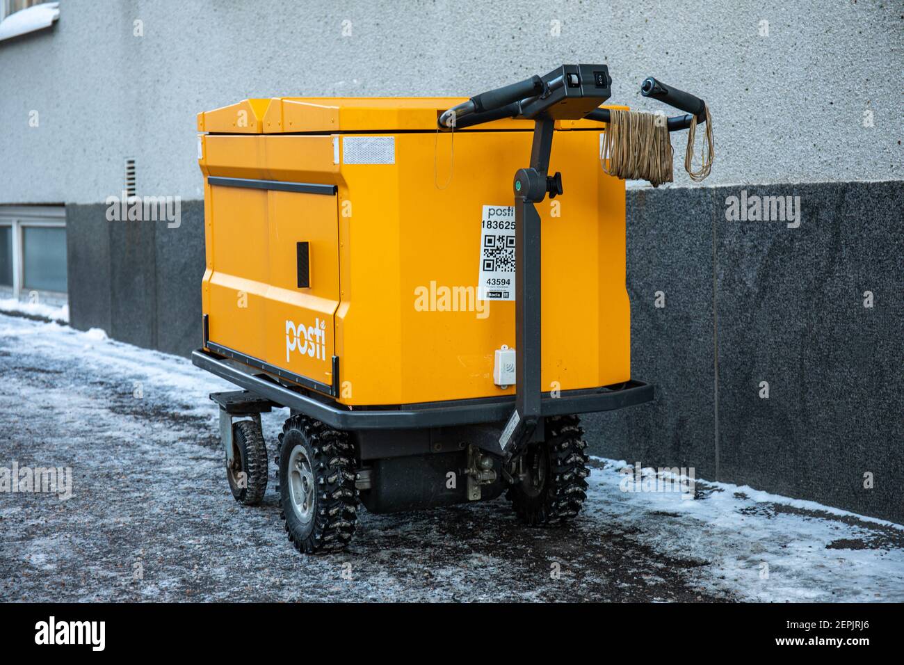 Electric mail delivery cart or trolley with Posti logo and brand color Stock Photo