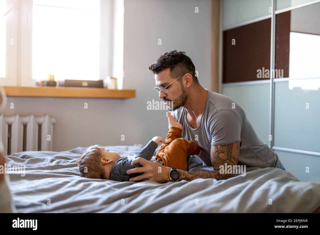 Father looking after his small son at home Stock Photo