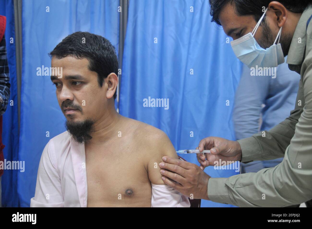 Health workers vaccinating people during the firststage of the