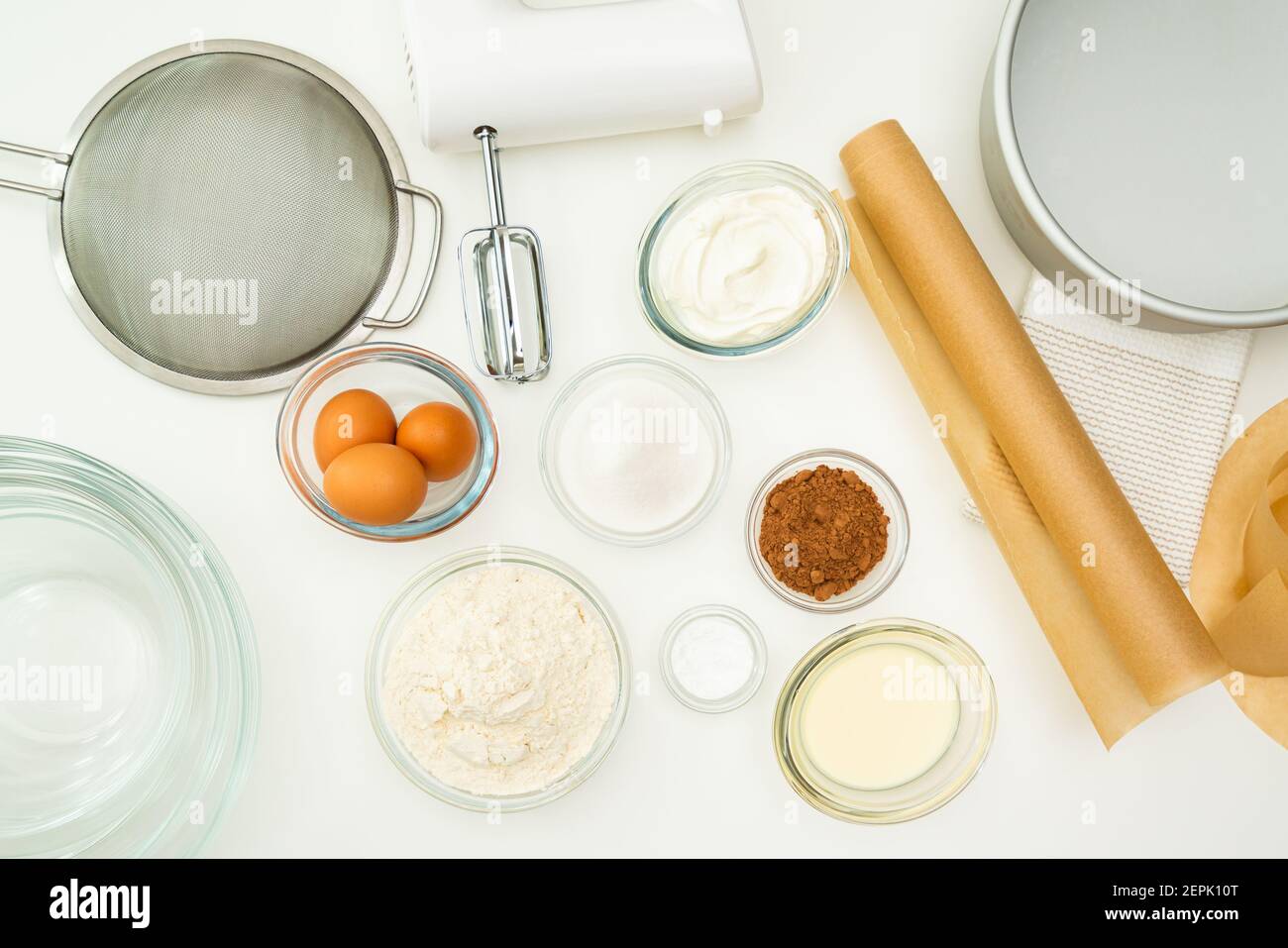 Chocolate cake recipe, baking process. Ingredients and dishes for making  cake close up on kitchen table, flat lay Stock Photo