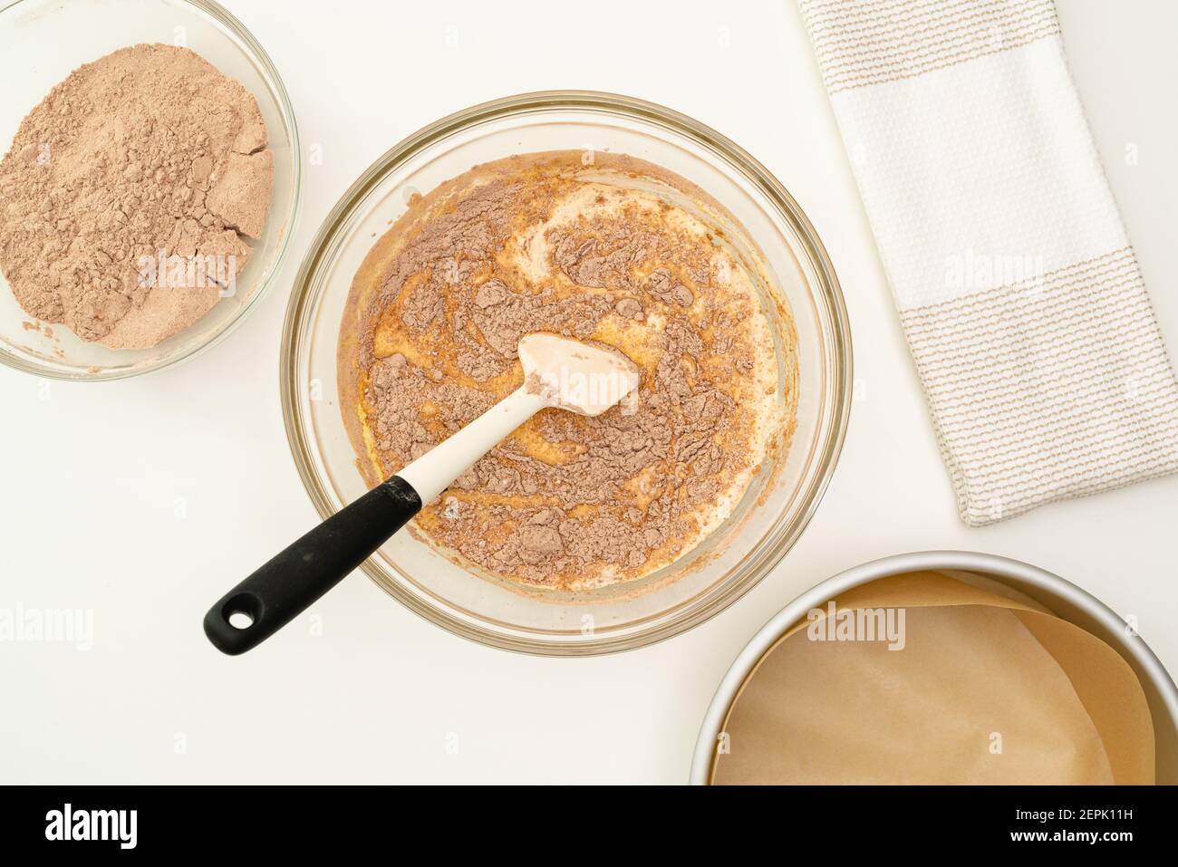 Chocolate cake recipe, baking process. Cake batter in a glass bowl close up  on kitchen table Stock Photo - Alamy