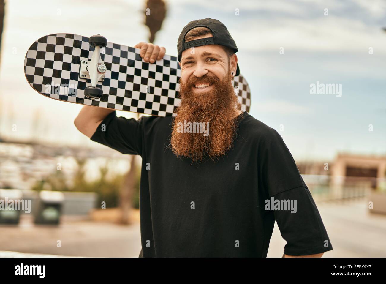 Young irish skater man smiling happy holding skate at the city Stock Photo  - Alamy