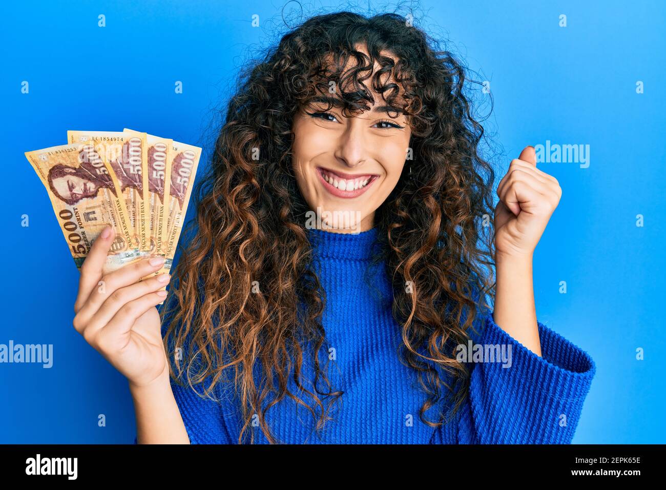 young-hispanic-girl-holding-5000-hungarian-forint-banknotes-screaming