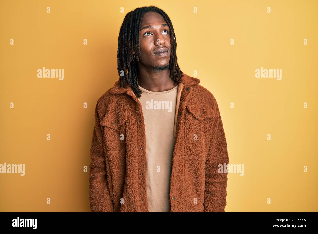 African american man with braids wearing brown retro jacket smiling ...