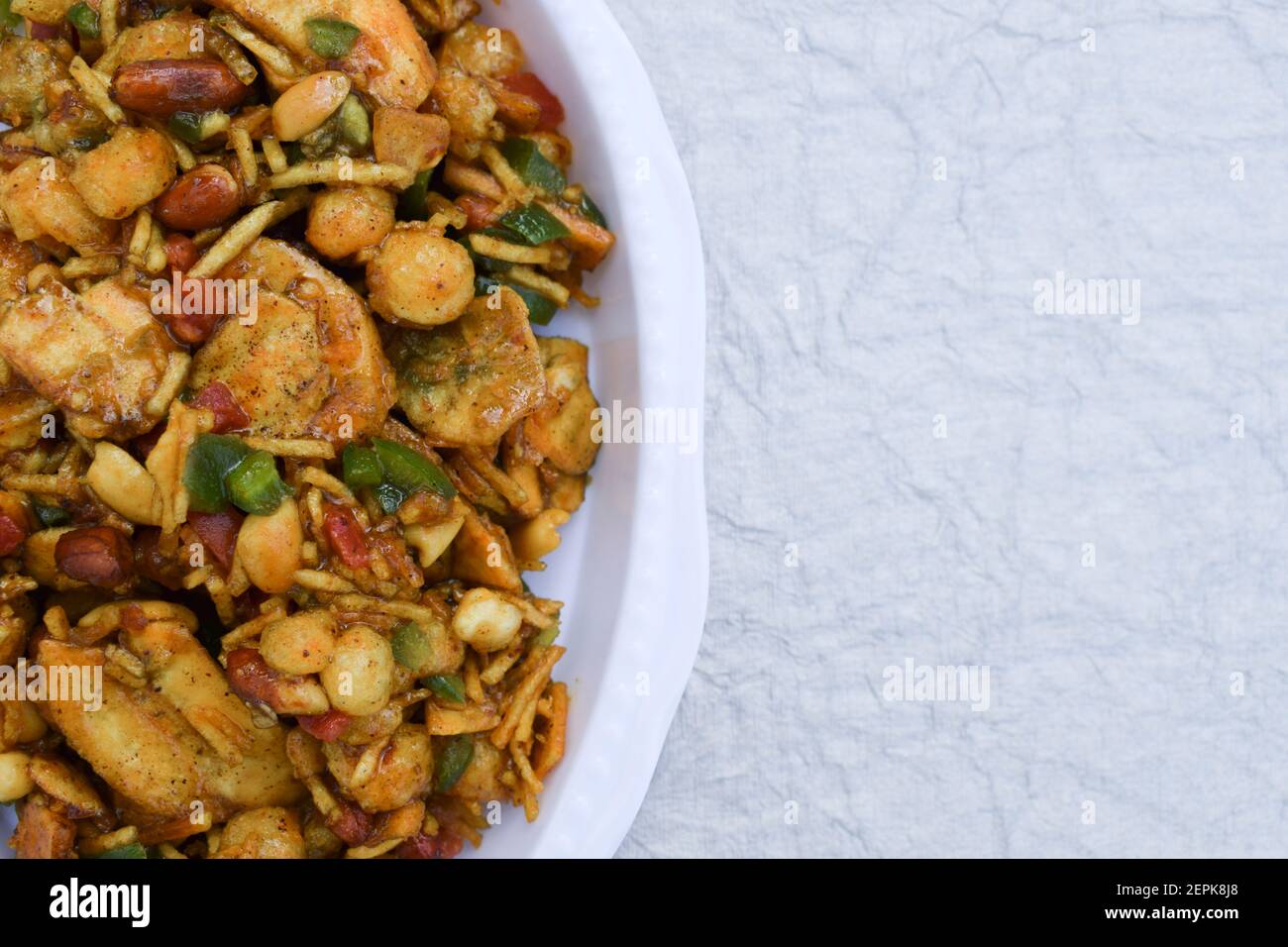 Farali bhelpuri made with faradi ingredients like banana chips, sago balls, mixture, tomato, capsicum on white background. Eaten during Fasting upawas Stock Photo