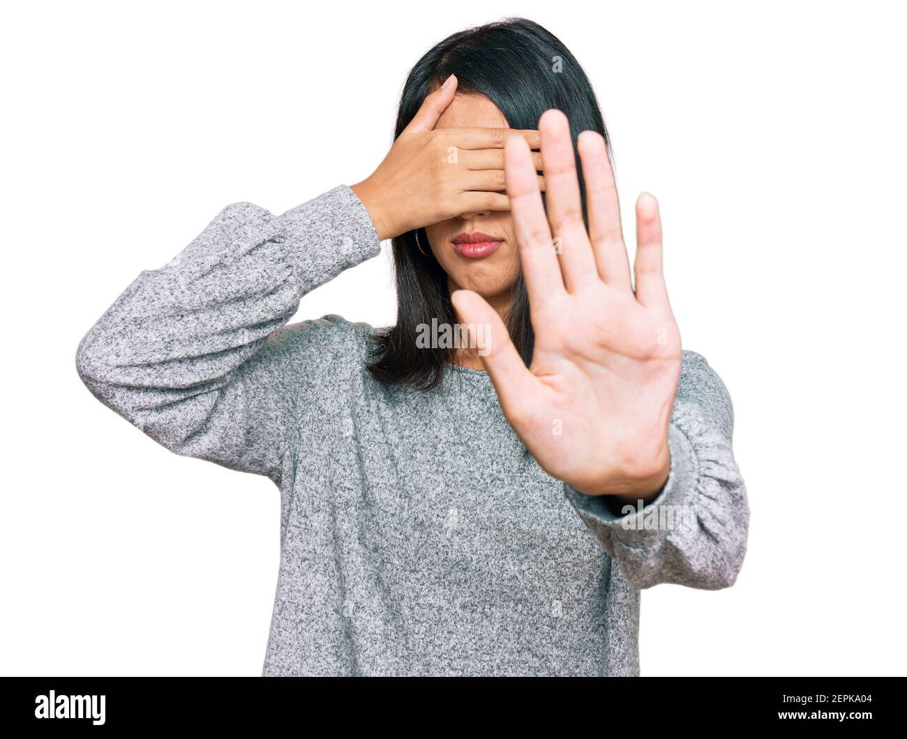 Beautiful asian young woman wearing casual clothes covering eyes with hands and doing stop gesture with sad and fear expression. embarrassed and negat Stock Photo
