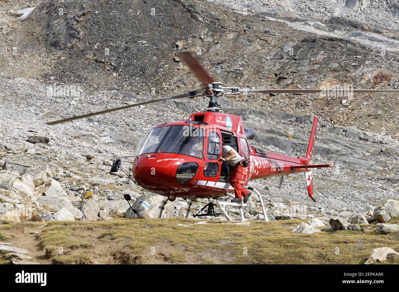 A red air rescue helicopter in the Swiss Alps, Switzerland Stock Photo