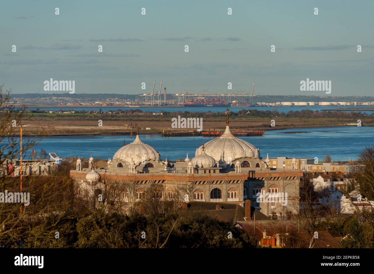 Looking across the domes of the Sikh temple Gravesend and across the Thames estuary towards Thamesport in Essex Stock Photo