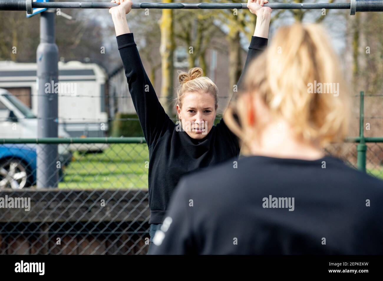 DEN BOSCH, NETHERLANDS - FEBRUARY 27: A woman is seen lifting weights outdoor on February 27, 2021 in Den Bosch, Netherlands. More than 300 gyms nationwide are protesting against the strict lockdowns measures that keep them closed. (Photo by Niels Wenstedt/BSR Agency/Alamy Live News) Stock Photo