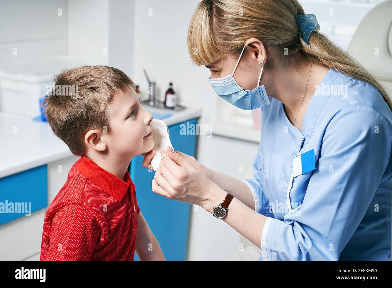 Female ENT doctor taking off or putting on a protective face mask from