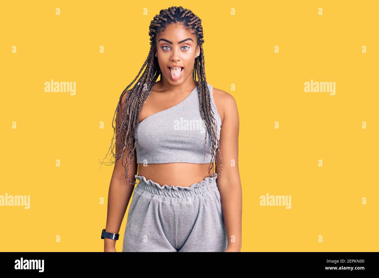 Young african american woman with braids wearing sportswear sticking ...
