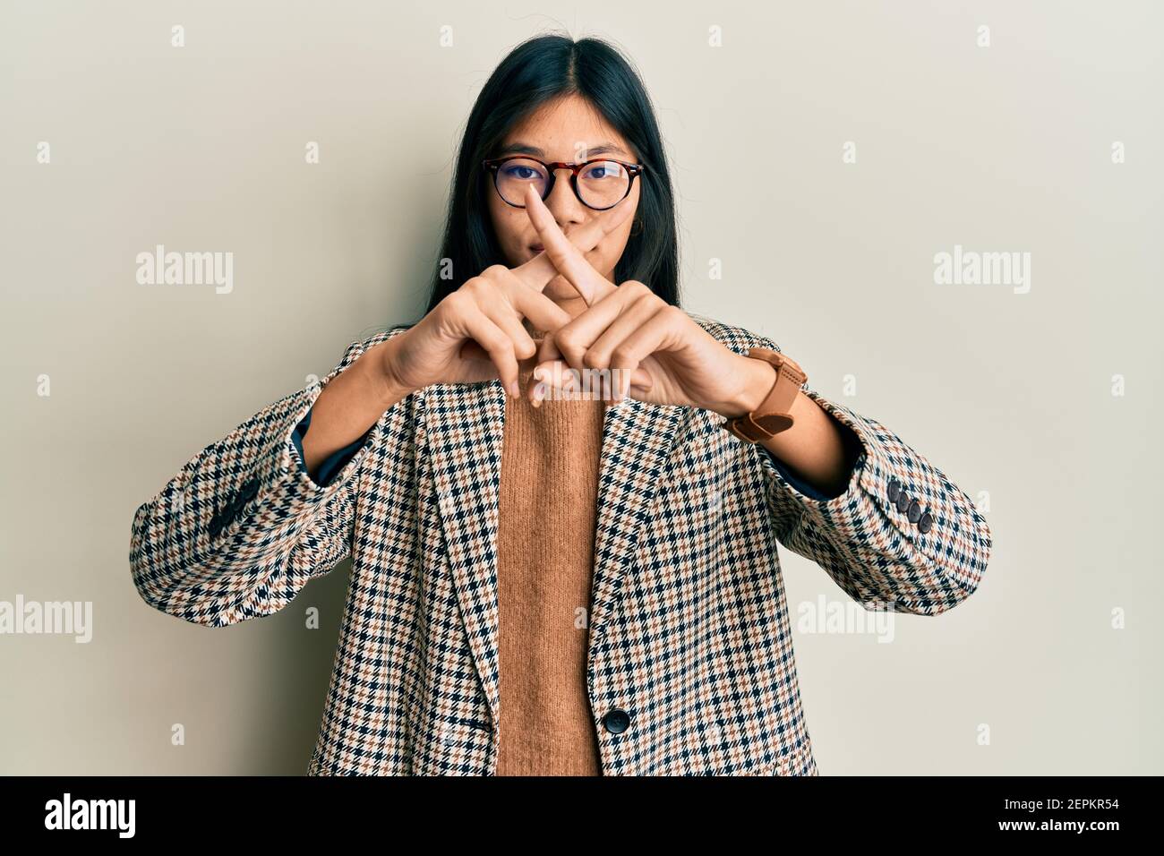Young chinese woman wearing business style and glasses rejection ...