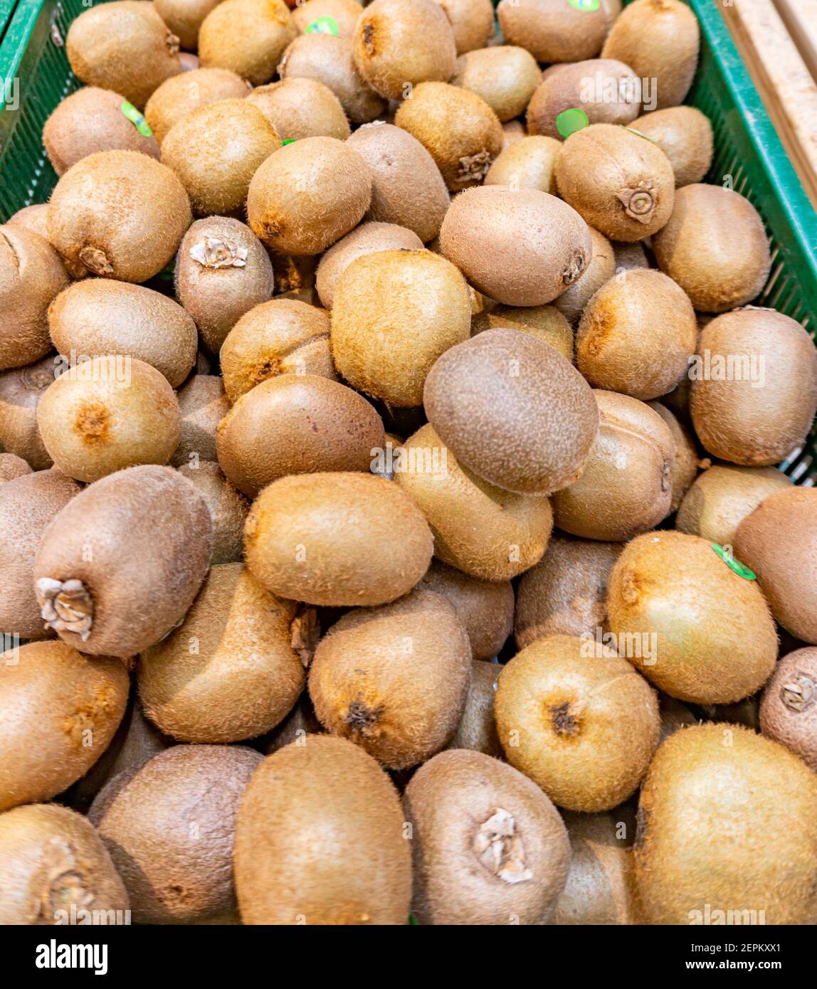 Juicy kiwi fruits in grocery shop, fresh kiwi fruits pleased in farm