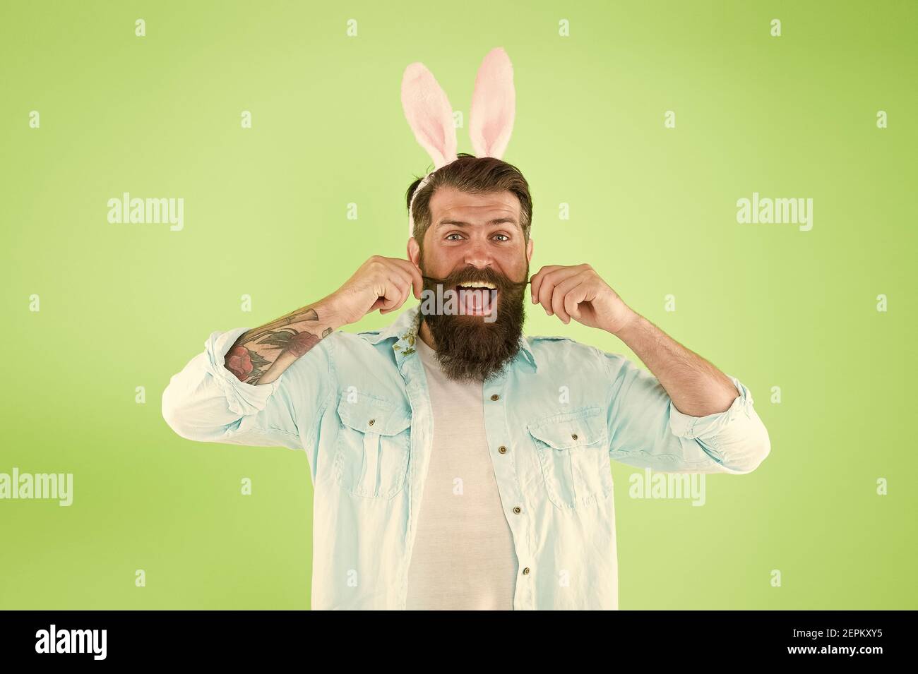 Just grow your hair. Bearded man wear bunny ears green background