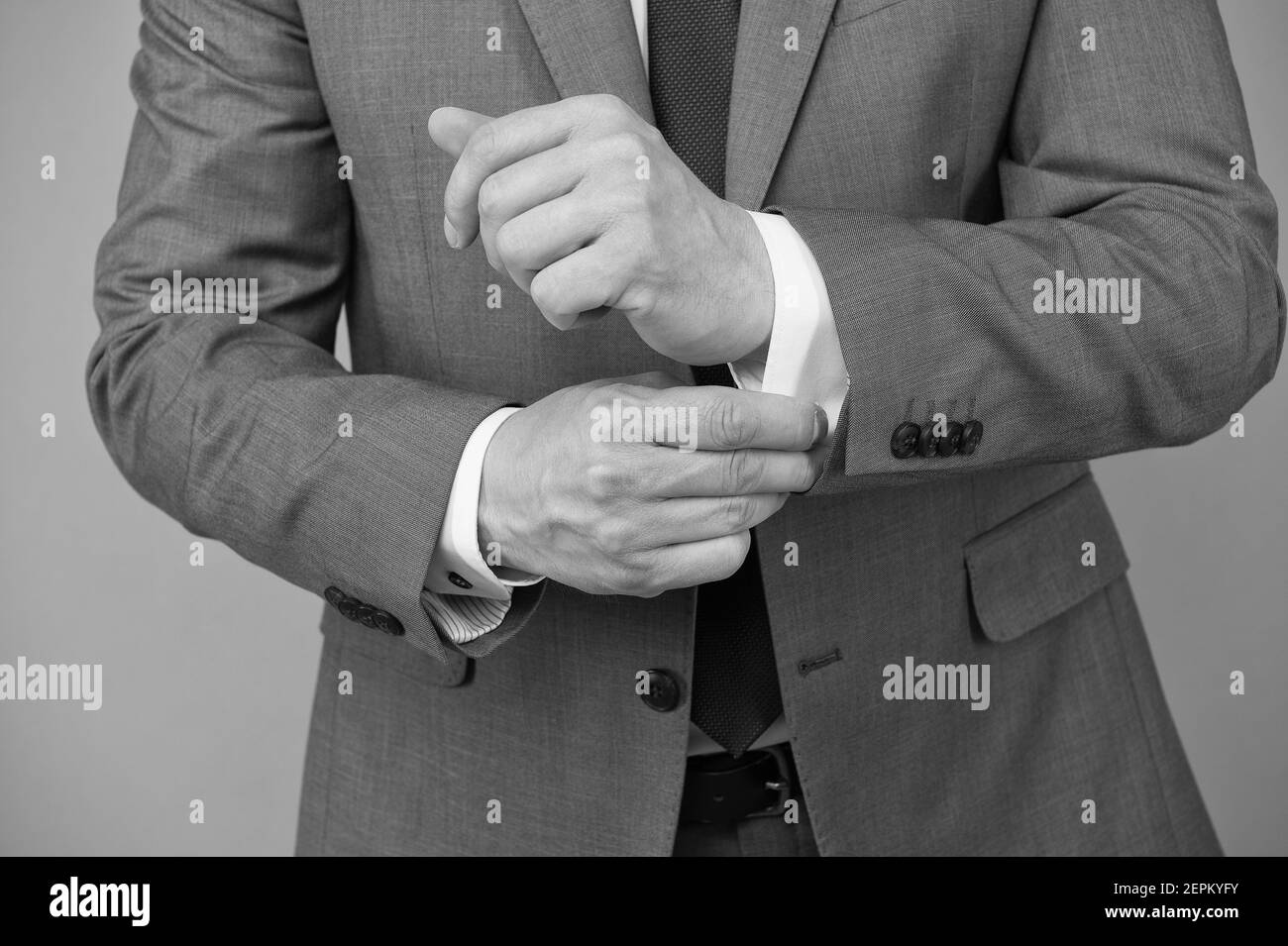 Hands adjusting sleeves formal suit business outfit, perfectionism