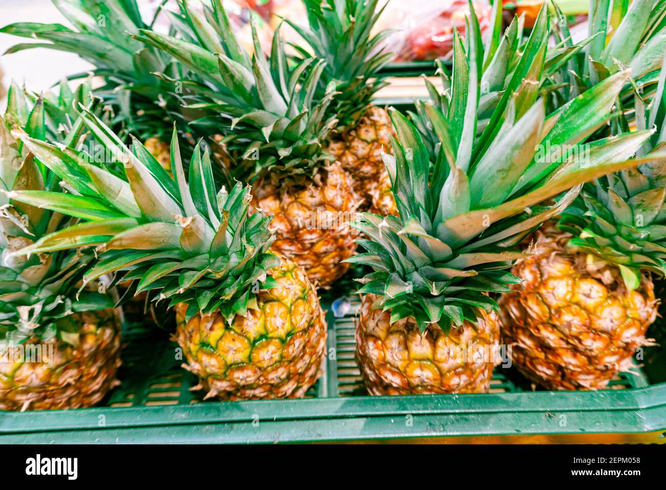 Fresh pineapples for sale in supermarket. A lot of pineapple fruit for