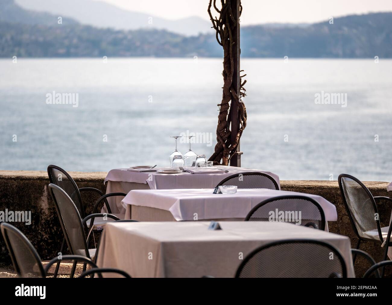 Empty restaurant tables with table setting during corona crisis in tourist spot Stock Photo