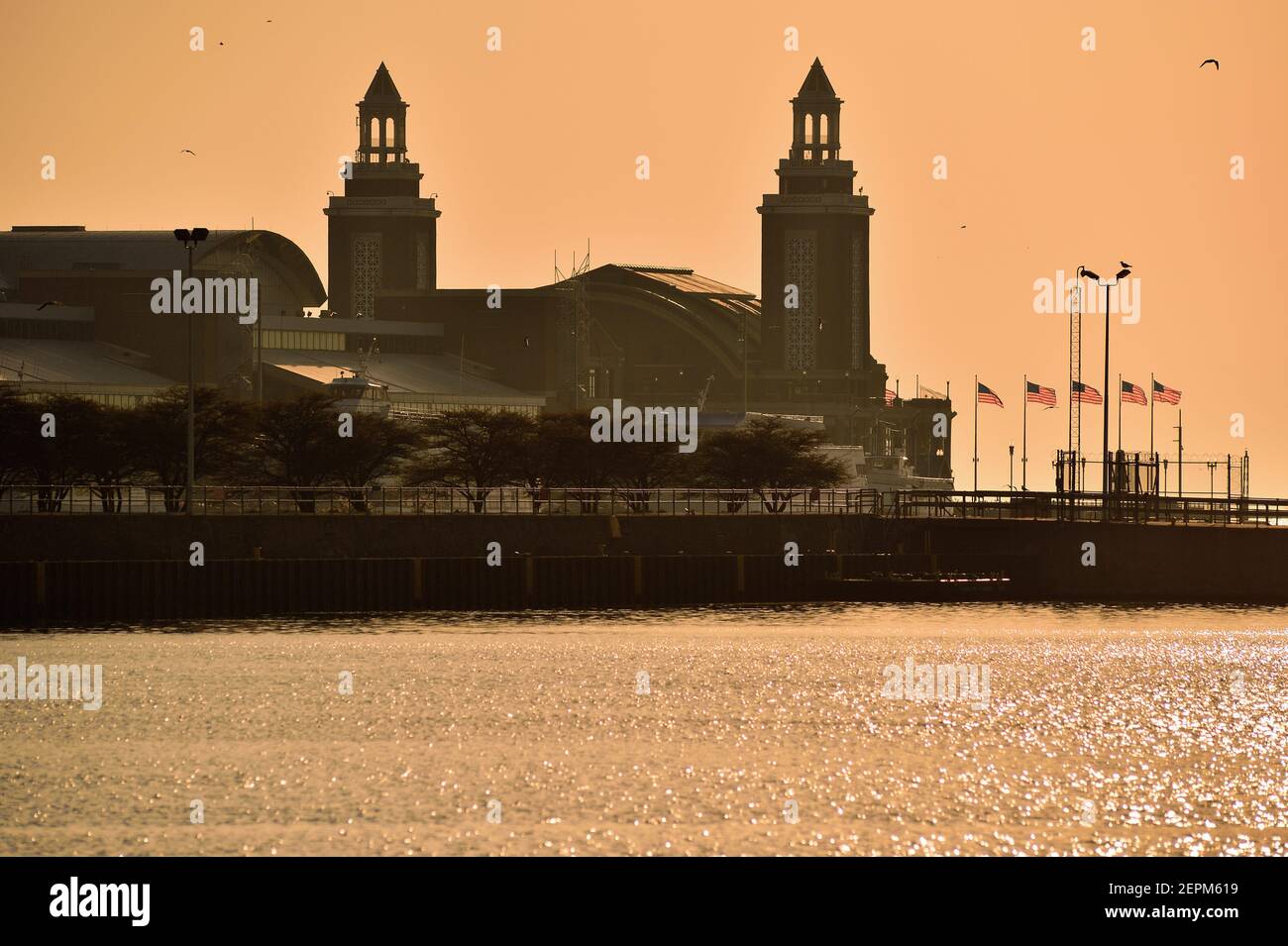 Chicago, Illinois, USA. The twin towers at the eastern end of Navy Pier bask between a lingering fog and the glow created by the rising sun. Stock Photo